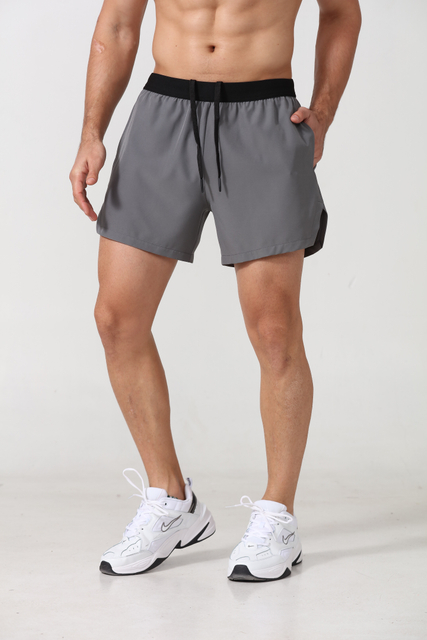 Short sportif masculin en polyester rapide Spandex avec poches latérales Fitness Workout Sports Gym de gymnase Shorts